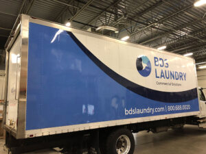 blue and white vinyl commercial truck wrap