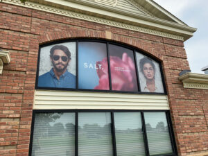 window graphics of man and woman on commercial property